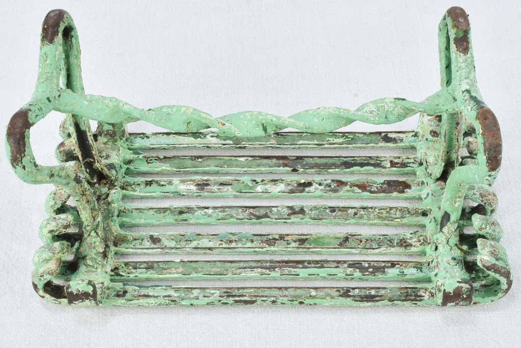 Antique garden footrest with green patina