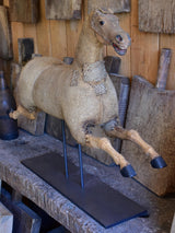 Antique French toy horse mounted on a stand