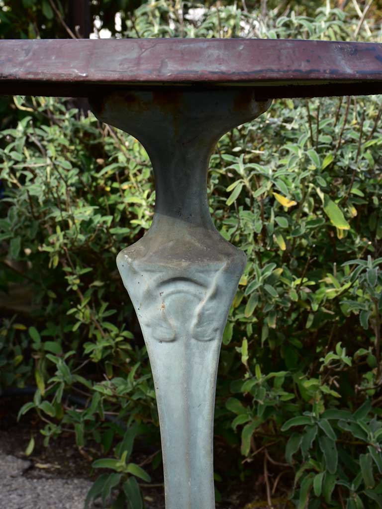 Art Nouveau cast iron bistro table with beige glass table top
