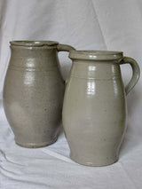 Two antique French milk pitchers - gray sandstone