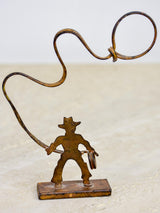 Antique cowboy lasso sculpture