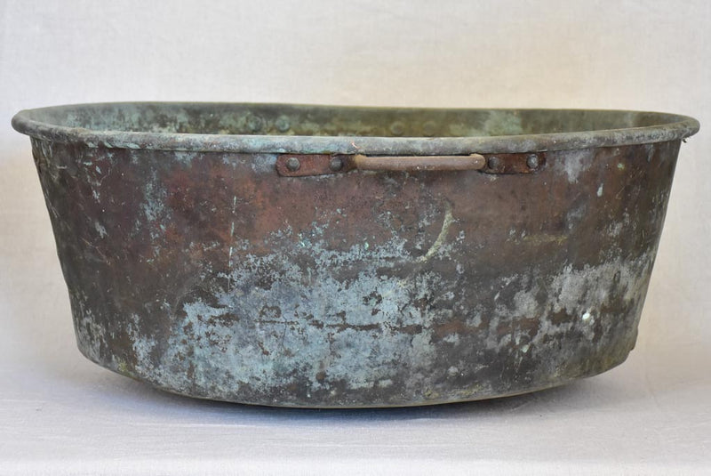 Broad antique French cauldron with two small handles and a drainage hole 30¼"