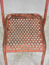 Aged red paint metal terrace chairs