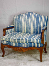 Large antique French Provincial armchair with striped blue and white upholstery walnut frame