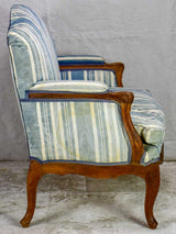 Large antique French Provincial armchair with striped blue and white upholstery walnut frame