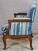 Large antique French Provincial armchair with striped blue and white upholstery walnut frame