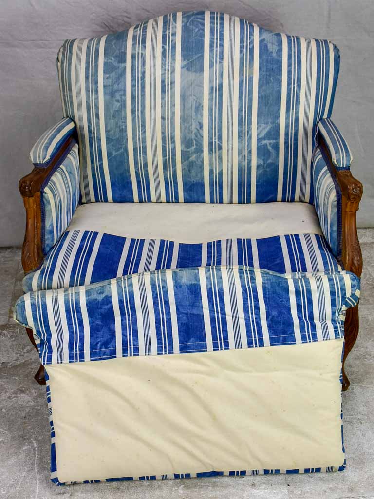 Large antique French Provincial armchair with striped blue and white upholstery walnut frame