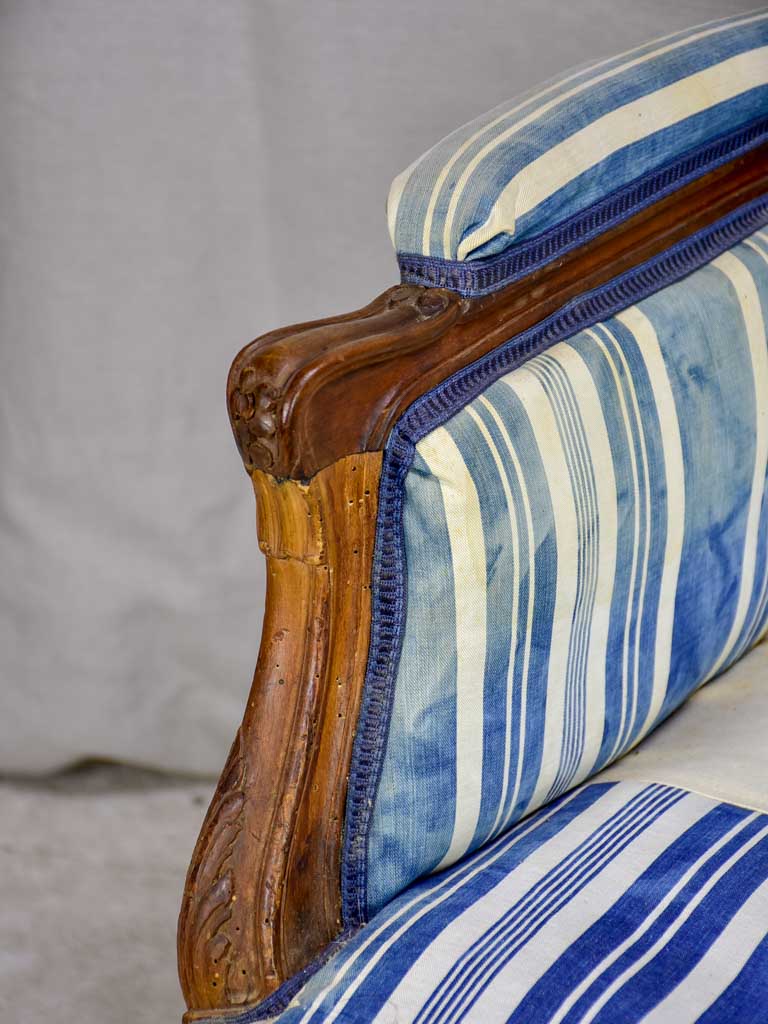 Large antique French Provincial armchair with striped blue and white upholstery walnut frame