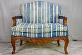 Large antique French Provincial armchair with striped blue and white upholstery walnut frame