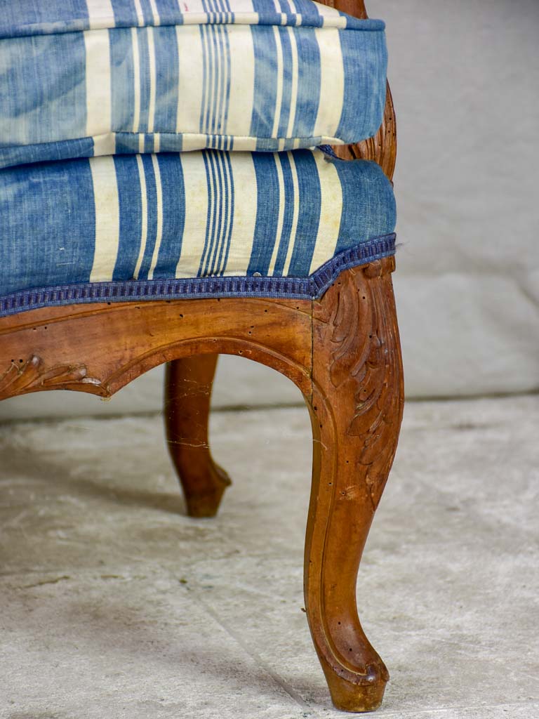 Large antique French Provincial armchair with striped blue and white upholstery walnut frame
