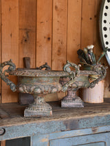 Pair of antique Medici urns with green / pink patina