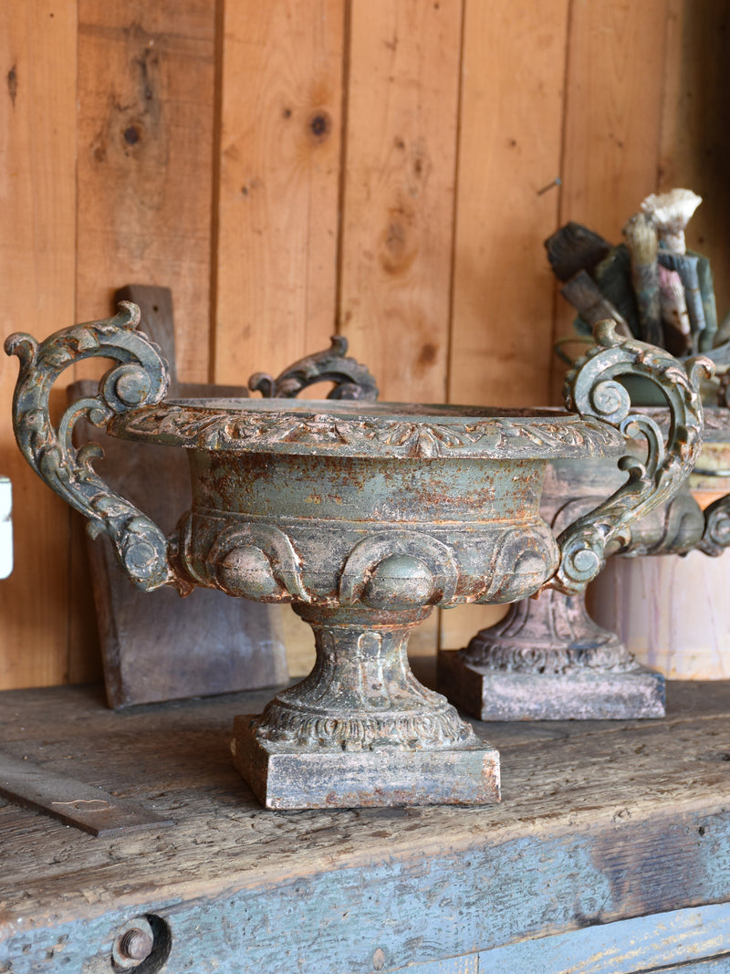Pair of antique Medici urns with green / pink patina