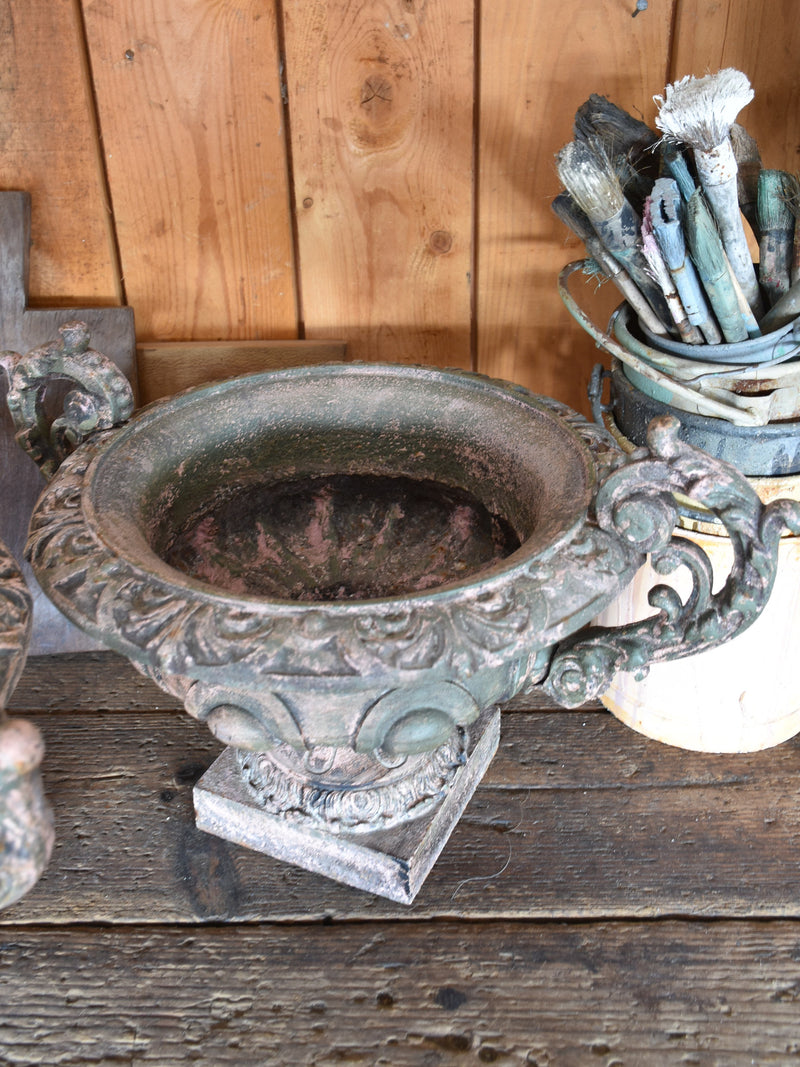Pair of antique Medici urns with green / pink patina