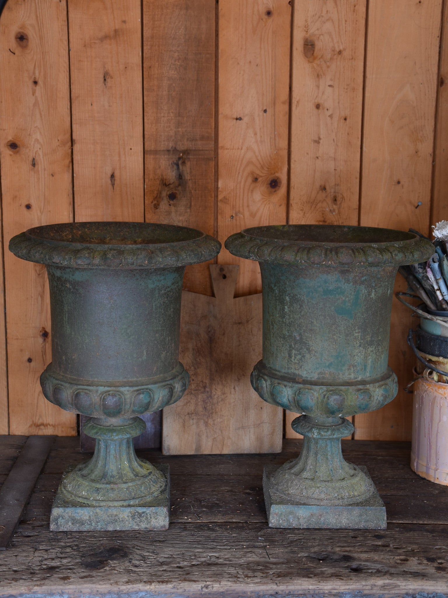 Pair of antique Medici urns with dark green patina