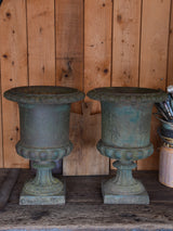 Pair of antique Medici urns with dark green patina