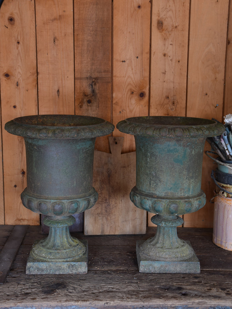 Pair of antique Medici urns with dark green patina