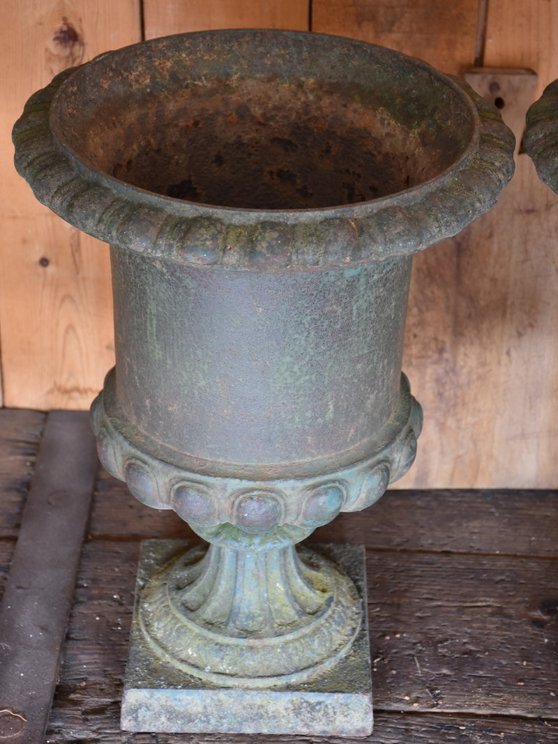 Pair of antique Medici urns with dark green patina