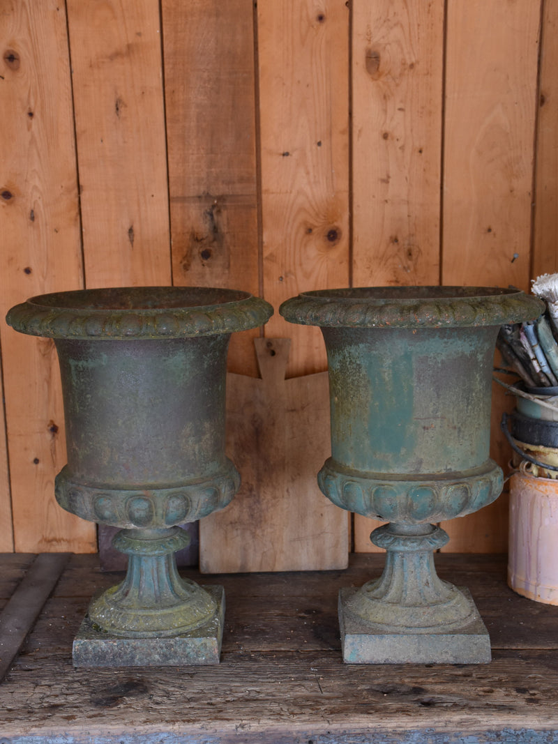 Pair of antique Medici urns with dark green patina