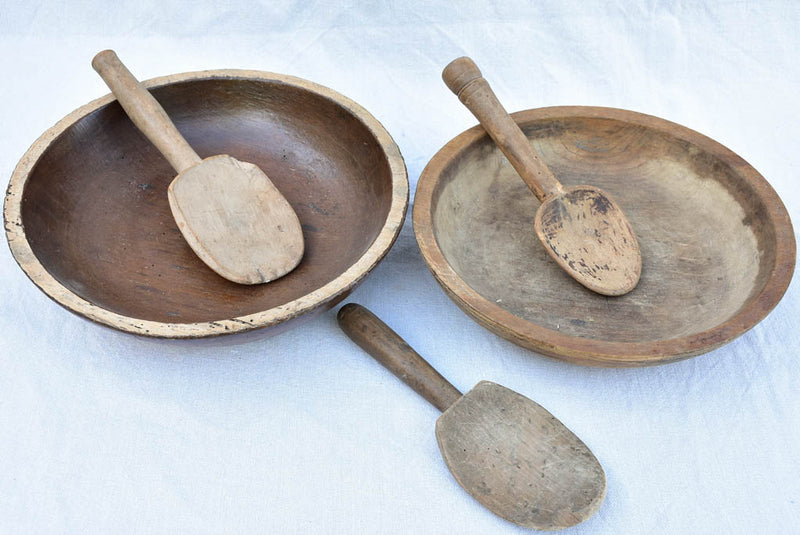Two primitive wooden cream bowls with three spoons from Angers