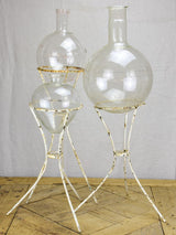 Group of three vintage flasks mounted on iron tripod stands