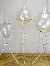 Group of three vintage flasks mounted on iron tripod stands