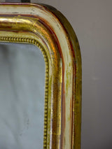 Rustic antique French Louis Philippe mirror with timeworn gilded frame