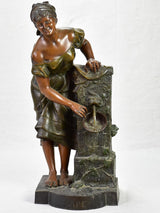 Early twentieth century metal sculpture of a lady at a fountain 30¼"