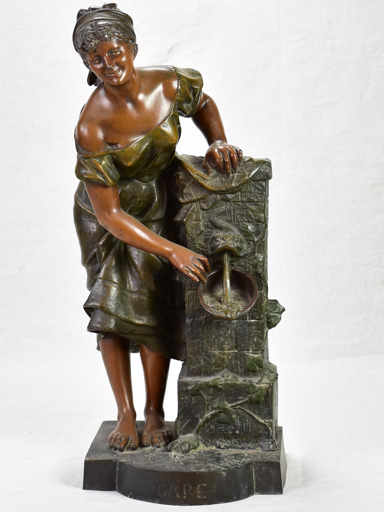 Early twentieth century metal sculpture of a lady at a fountain 30¼"