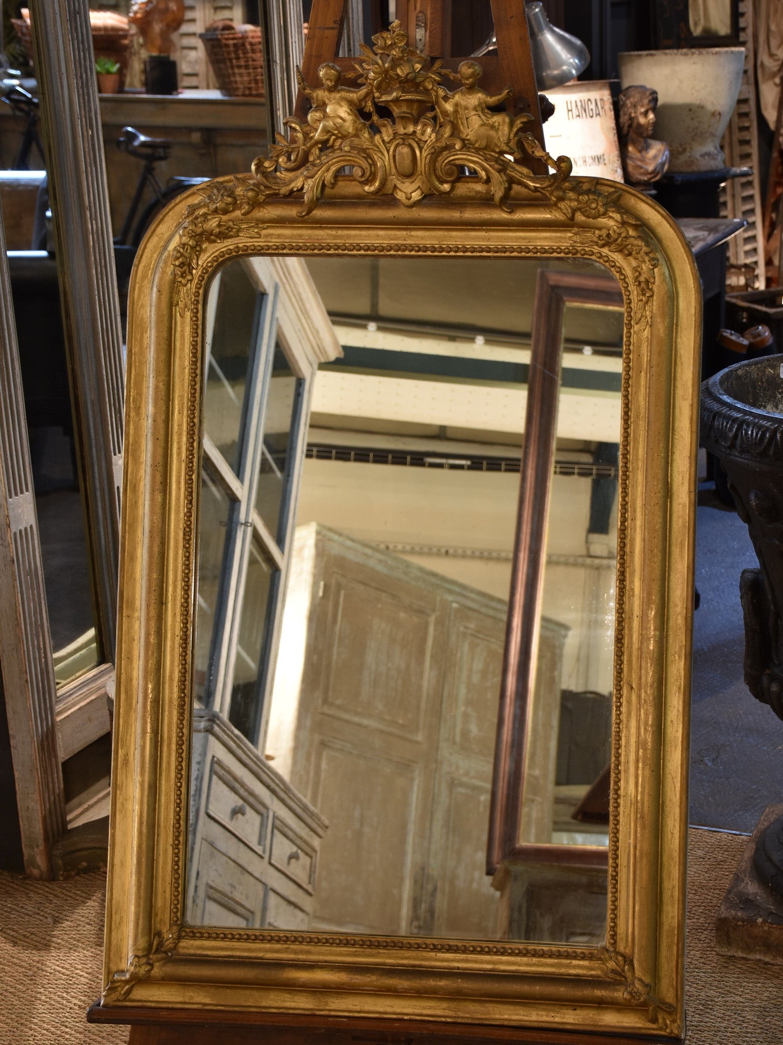 19th century Louis Philippe mirror with gilded frame and crest