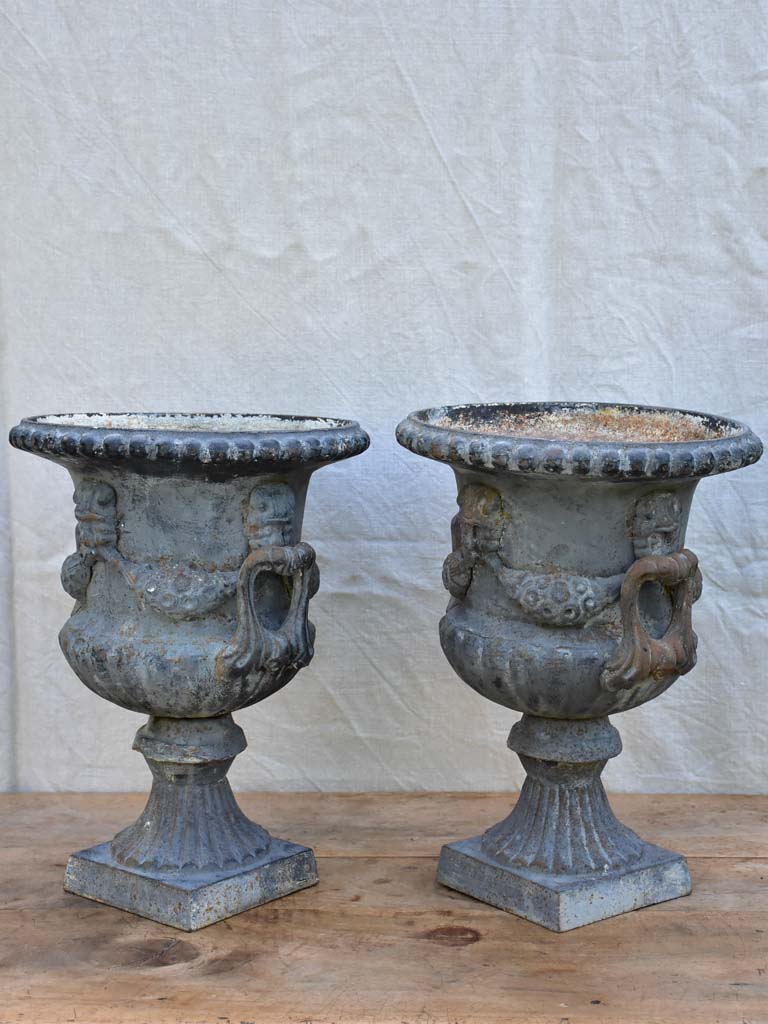 Pair of Napoleon III cast iron garden urns