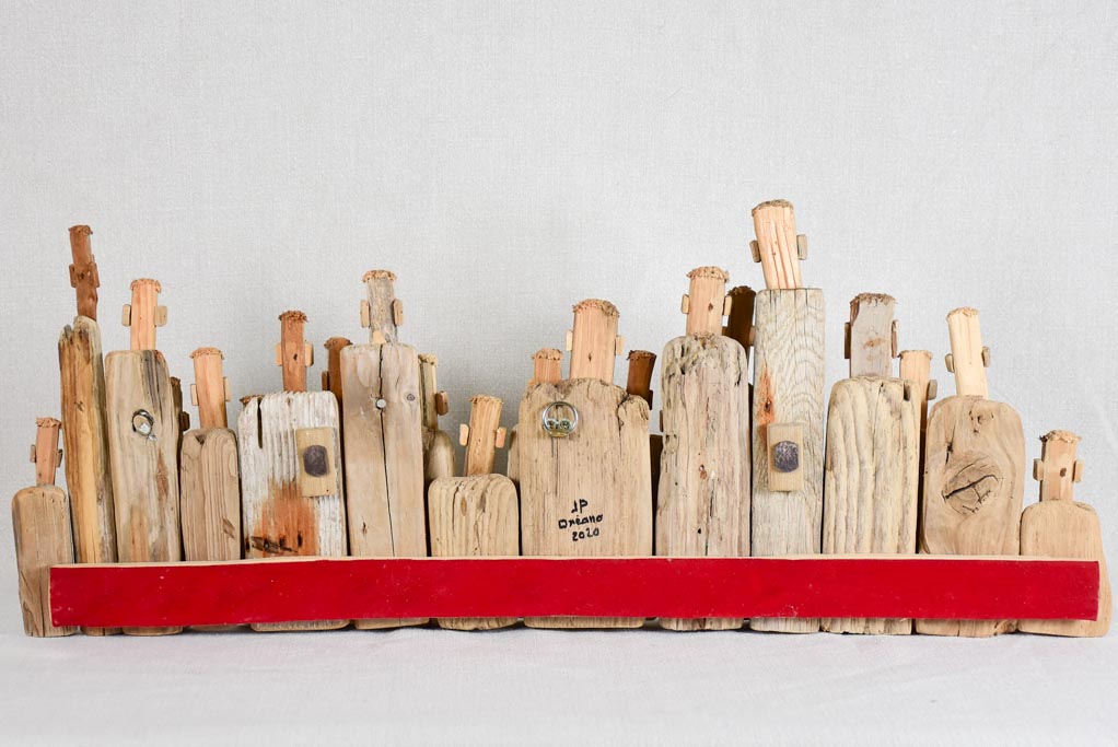 Panoramic driftwood sculpture by JP Dreano - 34 characters 27½"