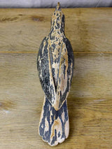 Rustic wooden sculpture of a raven - folk art