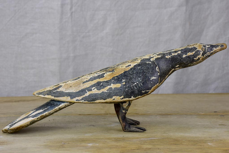 Rustic wooden sculpture of a raven - folk art