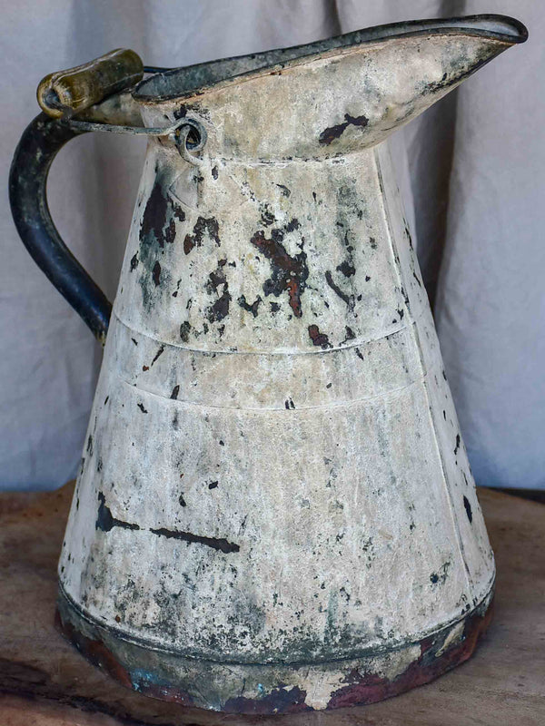 Antique French watering can with beige patina