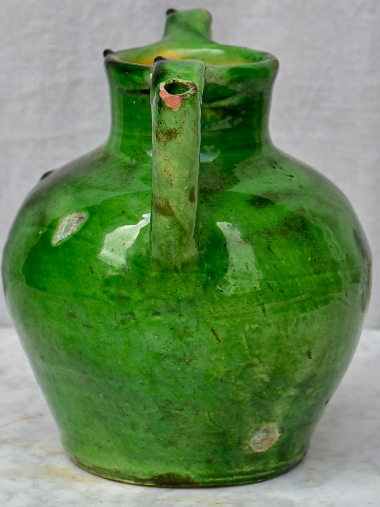 Antique French water jug with green glaze and spout