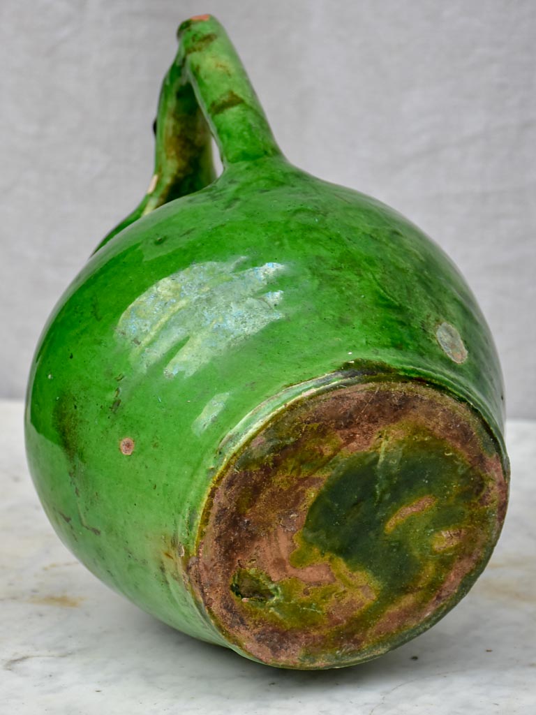 Antique French water jug with green glaze and spout