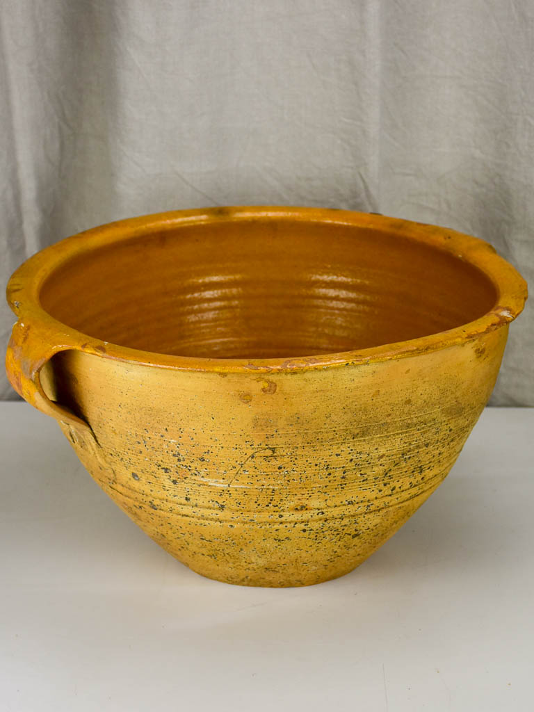 Very large antique Spanish bowl with orange glaze