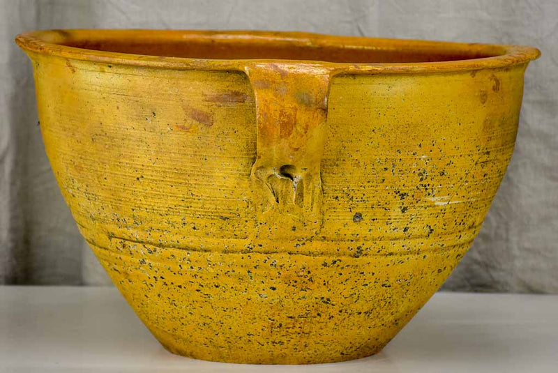 Very large antique Spanish bowl with orange glaze