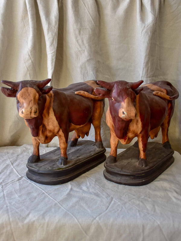 Pair of cow sculptures from a butcher's shop