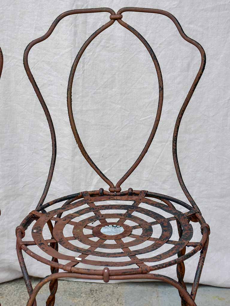 Pair of pretty black antique French garden chairs branded Vachon