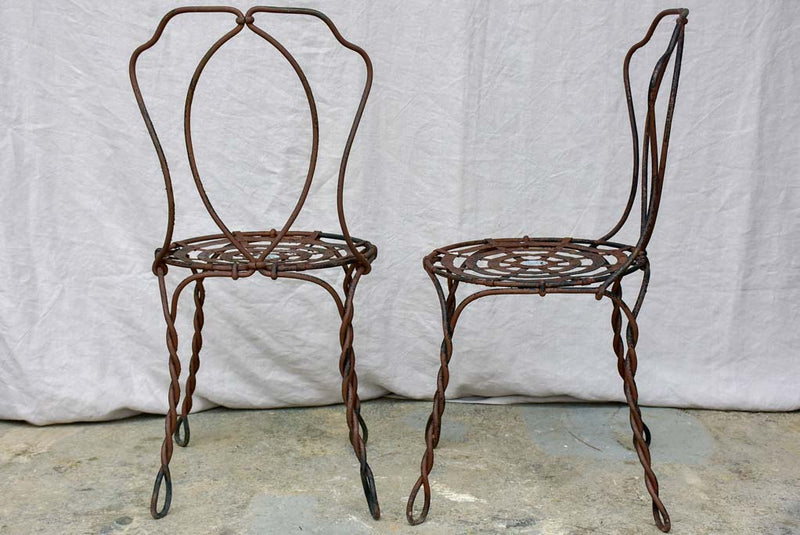 Pair of pretty black antique French garden chairs branded Vachon