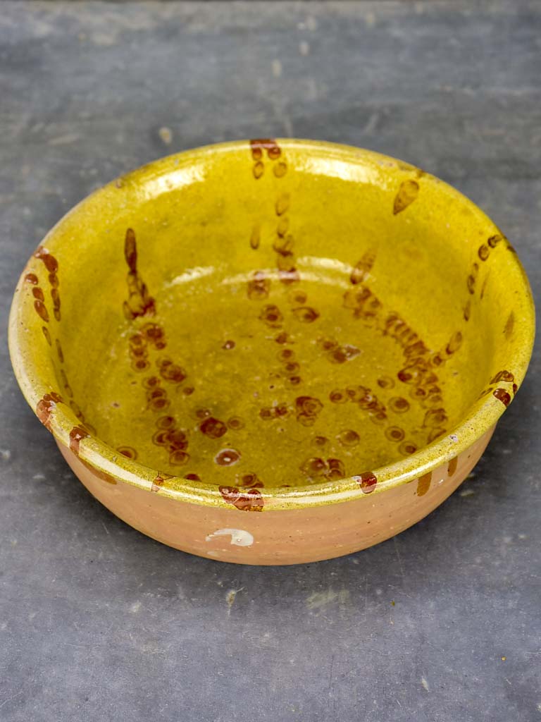 Antique French clay bowl with spotted glaze