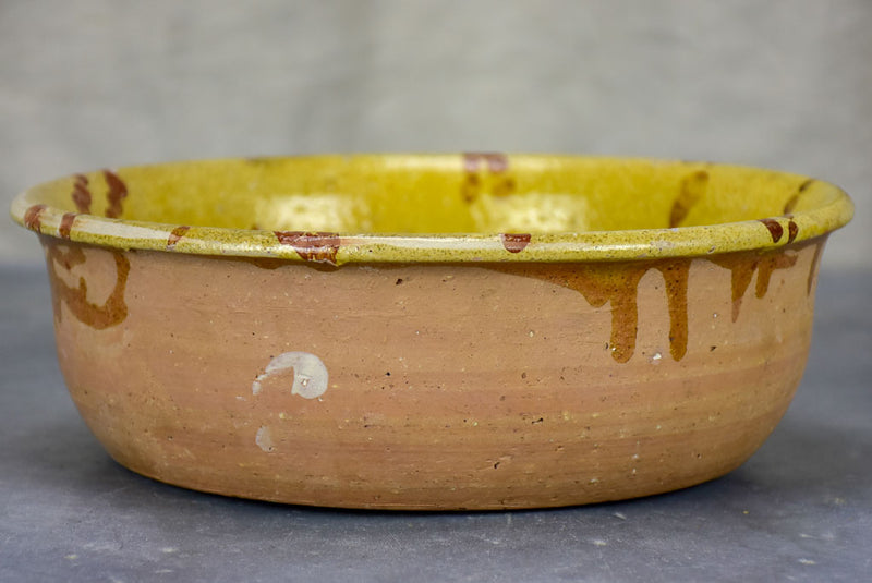 Antique French clay bowl with spotted glaze