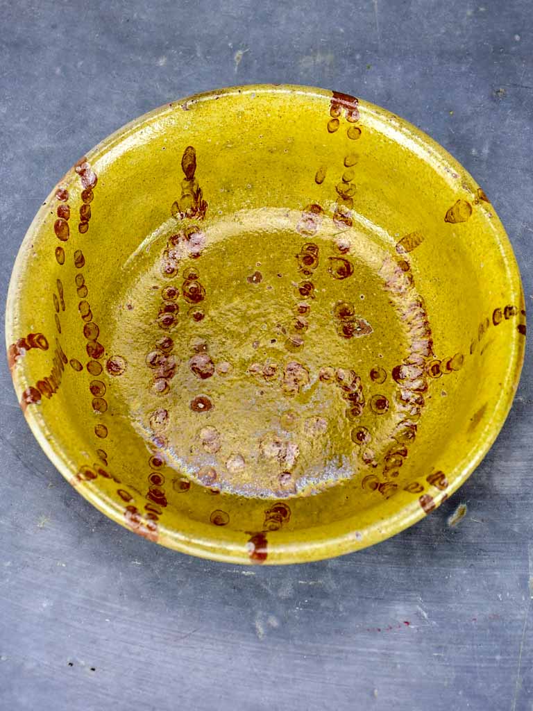 Antique French clay bowl with spotted glaze