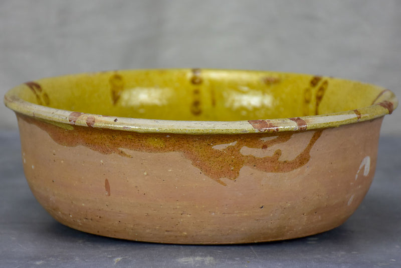 Antique French clay bowl with spotted glaze