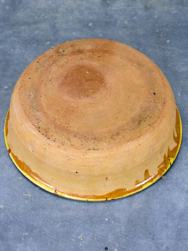 Antique French clay bowl with spotted glaze