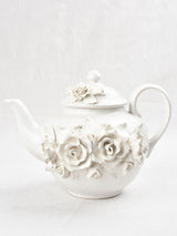 Vintage teapot decorated with sculptural flowers