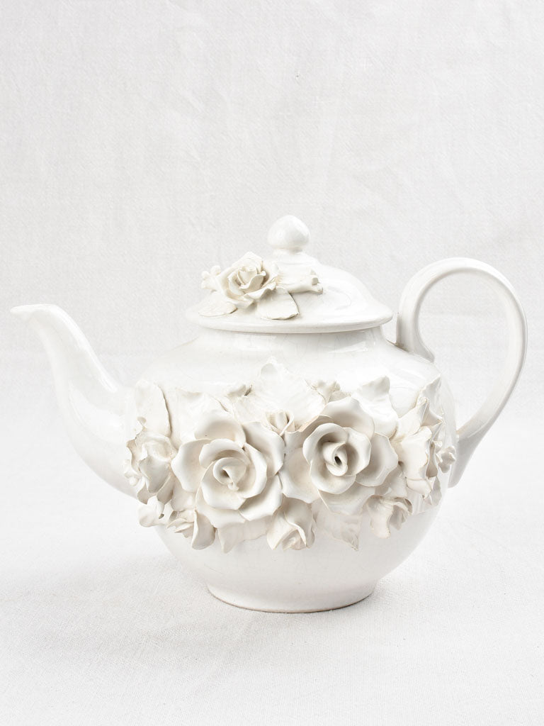 Vintage teapot decorated with sculptural flowers