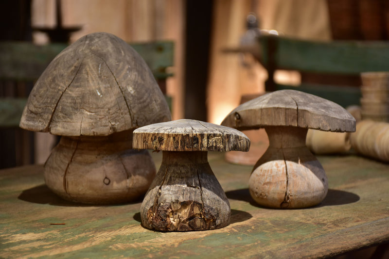 Three wooden French sculptures in the shape of mushrooms