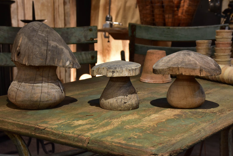 Three wooden French sculptures in the shape of mushrooms